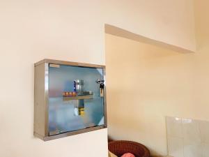 a small refrigerator in a corner of a room at Villa Kinandari Bukit Jimbaran in Jimbaran