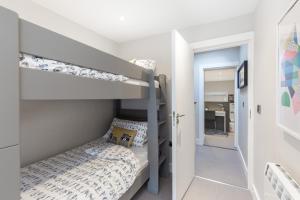 a small bedroom with a bunk bed and a staircase at Cheerful 3 bed in the heart of Fethard village in Fethard on Sea