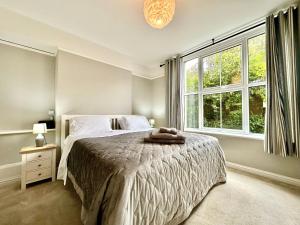 a bedroom with a bed and a large window at Smugglers View in Niton