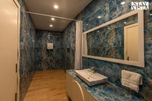 La salle de bains est pourvue d'un lavabo et d'une douche. dans l'établissement StayVista's Udaan Manor with Outdoor Pool, Jacuzzi & Lush Lawn with Gazebo & Bar, à Chandigarh