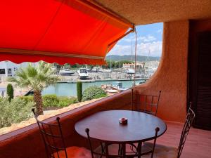 - Balcón con mesa y sillas y vistas al puerto en Appartement neuf 4km Saint-Tropez, en Saint-Tropez