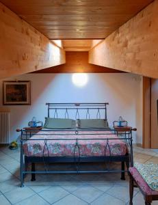 a bed in a room with a wooden ceiling at Bed & Breakfast Lucy in Bardolino