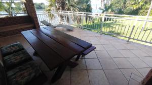a wooden bench sitting on top of a balcony at THE BOAT HOUSE, 53 Nkwazi Drive in Zinkwazi Beach
