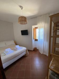 Postel nebo postele na pokoji v ubytování Il Tripode - Le Dimore del Bordone