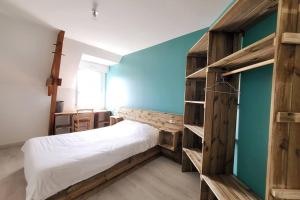 a bedroom with a bed and wooden shelves at Superbe maison spacieuse avec jardin in Angers