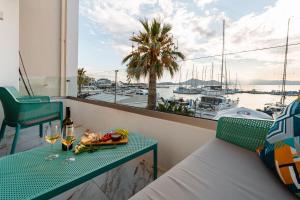 a balcony with a table and a view of a harbor at Infinity View Apartment in Naxos Chora