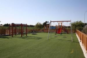a park with a playground with a swing set at Anchora in Paralimni