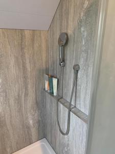 a shower with a shower head in a bathroom at The Hay Loft in Warnham