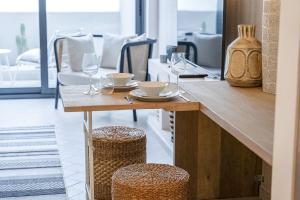 a wooden table with glasses and plates on it at Unique Loft design in JVC with relaxing in Dubai