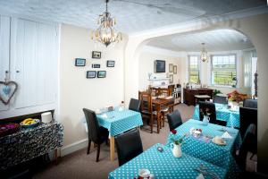 a living room with two tables and a dining room at Sea Jade Guest House in Bude