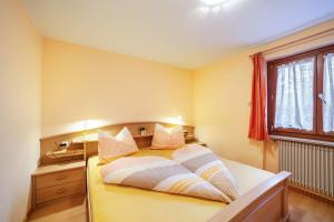 um quarto com uma cama, uma secretária e uma janela em Oberkapillhof em Meltina