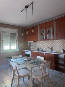 a kitchen with a table and chairs in a kitchen at Seaside Blue Coast Apartment in Anavissos