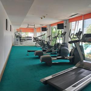 a gym with several treadmills and cardio machines at Apartemen Startegis di Mega Kuningan in Jakarta