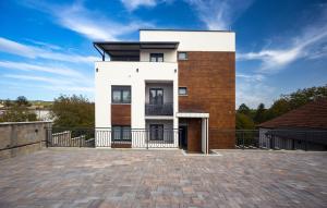 a large white house with a roof at M&A Apartmani in Vrdnik