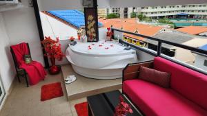 a balcony with a large boat on the floor of a building at Happy Beach Jomtien Guesthouse in Jomtien Beach