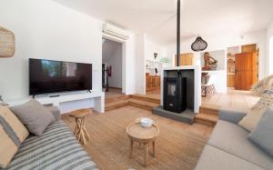 a living room with a couch and a fireplace at Private Villa near Ibiza town (10min) in Sant Josep de Sa Talaia