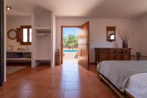 a bedroom with a bed and a view of a pool at Private Villa near Ibiza town (10min) in Sant Josep de Sa Talaia +19 photos