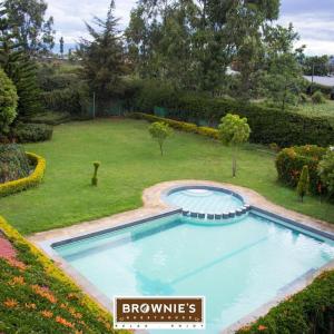 a large swimming pool in a yard with a yard at Brownies Deluxe in Nakuru