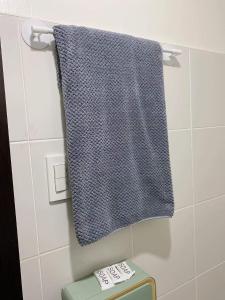 a blue towel hanging on a wall in a bathroom at Blessed Condo for 6 - include net, water & electric in Manila