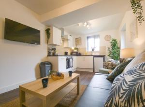 a living room with a couch and a table at Principality Suites - Two Bed Apartment by Property Promise in Cardiff