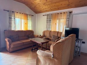 a living room with a couch and a table at Vila Deda in Lezhë