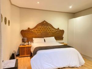 Postel nebo postele na pokoji v ubytování Tuscany Guesthouse