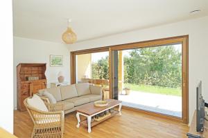 a living room with a couch and a table at Casa Montagna in Oy-Mittelberg