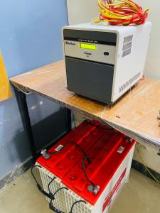 a computer sitting on a table next to a box at Negi Lodge Chandigarh in Chandīgarh