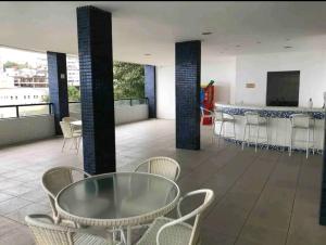 a room with a table and chairs and a bar at Apartamento Solar Rio Vermelho in Salvador