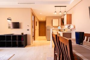 a kitchen and living room with chairs and a table at Suite Apt Bourgogne N°2, 2 P in Casablanca +20 photos