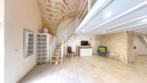 a room with stairs and chairs and a desk at Lupiae Casa Vacanze in Lecce