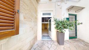 a door to a building with a potted plant at Lupiae Casa Vacanze in Lecce
