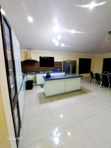 a room with a kitchen and a living room at Large 3 bedroom villa with Pool in Sonaisali Nadi in Nadi