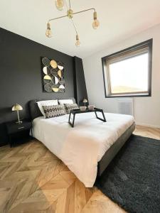 a bedroom with a large bed with a table on it at Studio Esplanade bord du Lac in Aix-les-Bains