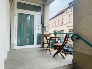 a patio with a table and a chair on a balcony at Design City Apartment, Modern, ebenerdig, Top Lage in Weinheim