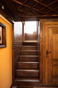 a stairway with a wooden door in a building at Къща ЕТНО in Koprivshtitsa