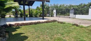 a driveway with a gate and a grass yard at Large 3 bedroom villa with Pool in Sonaisali Nadi in Nadi