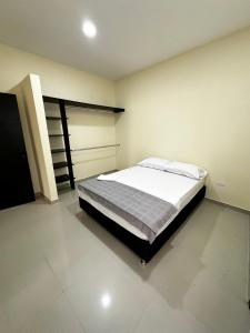 1 dormitorio con 1 cama grande en una habitación en Apartamentos sin fronteras, en Leticia