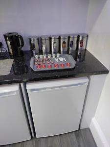 a kitchen counter with a counter top with a stove at Moden Stylish large Southsea Apartment with jacuzzi bath sleeps 6 in Portsmouth +21 photos