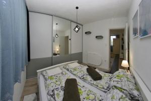 - une chambre avec un lit et un grand miroir dans l'établissement Cable Car Apartment Baščaršija, à Sarajevo