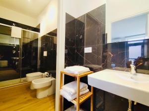a bathroom with a sink and a toilet at HH Hermoso Housing Asti in Asti +96 photos