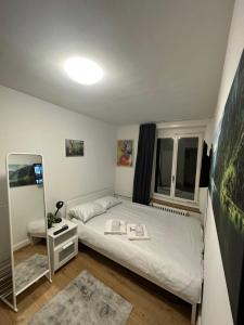 a small bedroom with a bed and a mirror at NTN HOUSE in St. Gallen