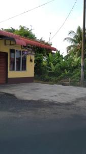 a building with a parking lot in front of it at Tina Homestay Budget in Ketereh