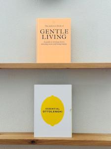 a shelf with two books and a box on it at Traumurlaub auf dem Brandmanngut in Marquartstein