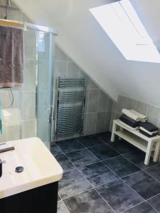 a bathroom with a shower and a sink and a stairs at Mourne Views 2 Bed Apartment in Kilkeel