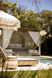 a swimming pool with a chair and a umbrella and a swimming pool at m a r ė a in José Ignacio