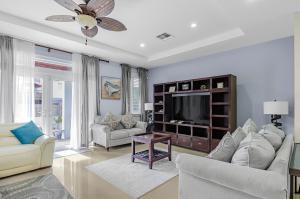 a living room with a couch and a tv at Blu Diamond Luxury Estate in Nassau