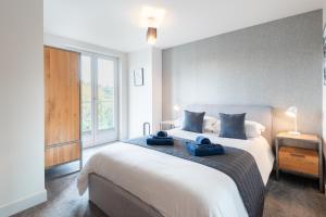 a bedroom with a large bed with blue towels on it at Parkview, St Andrews in St. Andrews