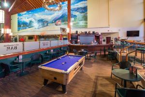 a room with a pool table and a bar at Super 8 by Wyndham Sherwood Park/Edmonton Area in Sherwood Park