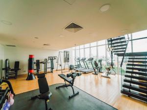 a gym with treadmills and exercise equipment in a building at Serenity Private Pool Sky Villas in Ho Chi Minh City